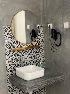 a bathroom with a sink and a mirror on a wall at Silvan Garden Retreat in Tanah Rata +55 photos