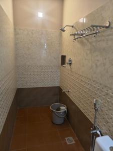 a bathroom with a toilet and a bucket at Greenway Retreat Resort in Puducherry Airpoert +24 photos