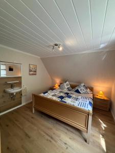 a bedroom with a bed and a sink in it at Ferienhaus Gerda Wohnung 1 in Westochtersum