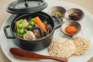 a plate of food with a pot of food on it at The Gate Hotel Osaka by Hulic in Osaka +243 photos