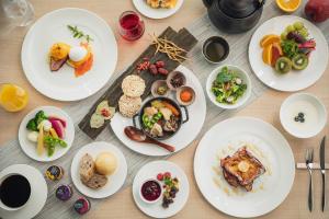 a table with white plates of food on it at The Gate Hotel Osaka by Hulic in Osaka