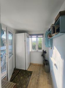 a kitchen with a white refrigerator in a room at Stufstock Hostel in Sulina