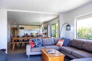 a living room with a couch and a table at Port Jackson Paradise in Square Top Island +29 photos