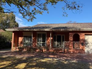 an old brick house with a driveway at Central Private Room - Stroll to ANU & City in Turner