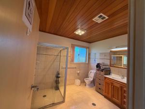 a bathroom with a shower and a toilet and a sink at Central Private Room - Stroll to ANU & City in Turner +19 photos