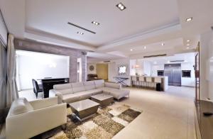 a large living room with white furniture and a fireplace at Villa Riviera Eilat in Eilat