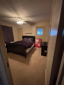 a bedroom with a bed and a ceiling fan at Updated cozy in central Cleveland in Cleveland +9 photos