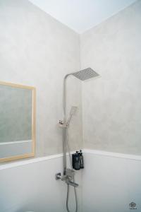 a shower head in a bathroom with a mirror at Luna Vista Tourist Inn in Puerto Princesa City +43 photos
