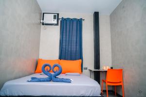 a bedroom with a bed with two blue swans on it at Luna Vista Tourist Inn in Puerto Princesa City