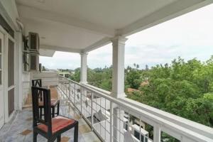 a chair sitting on a balcony with a view at Nathaliya Tourist Hotel in Seeduwa