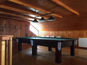 a pool table in a room with wooden walls at Gagieti in Gudauri