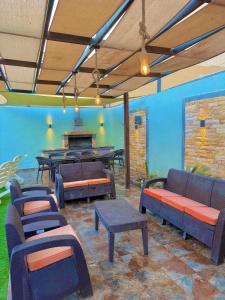 a room with chairs and tables and a table with benches at La Gabbia Chalets in Al Kafrayn