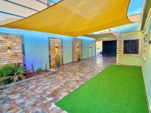 an empty patio with a green floor in a house at La Gabbia Chalets in Al Kafrayn