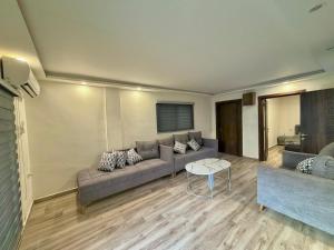 a living room with a couch and a table at La Gabbia Chalets in Al Kafrayn