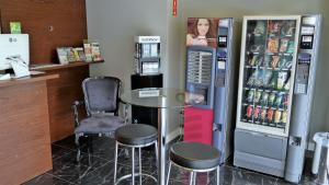 a bar with a table and two chairs and a refrigerator at Mr. Hostel Business Lodge in Campinas