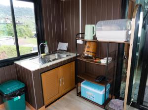 a kitchen with a sink and a counter top at สกายวันเดอร์ ภูทับเบิก in Ban Tha Kok Hai