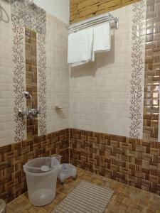 a bathroom with a toilet and a shower at Nandi Roop Homestay in Panuānaula