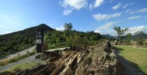 a sign on the side of a road next to a mountain at Yeongwol cubezone in Yeongwol