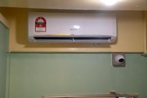 a kitchen with a air fryer on a wall at Bestow Capsule Hostel in Kuala Lumpur