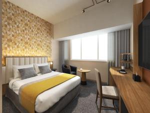 a hotel room with a bed and a desk at Art Hotel Narita in Narita