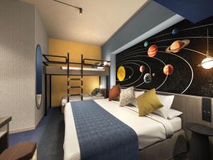 a bedroom with a bed and a mural of planets at Art Hotel Narita in Narita