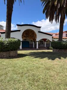 a house with a palm tree in a yard at La mansión in Salta +2 photos