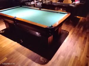 a pool table sitting on top of a wooden floor at La mansión in Salta