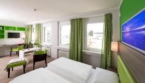 a hotel room with a bed and a desk at Bonnox Boardinghouse & Hotel in Bonn