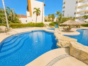 a swimming pool at a resort with a resort at Mykonos Recently remodeled 1BR Beach Escape great view! in San José del Cabo +28 photos