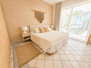a bedroom with a bed and a large window at Mykonos Recently remodeled 1BR Beach Escape great view! in San José del Cabo