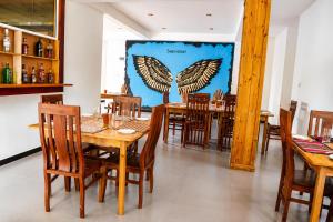 a dining room with wooden tables and chairs at 3 Arch Resort Ella in Ella +53 photos
