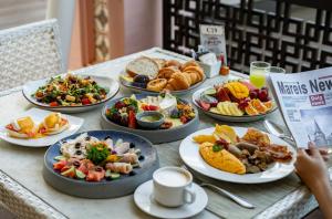 a table with many plates of food on it at Centara Grand Beach Resort Phuket in Karon Beach +288 photos