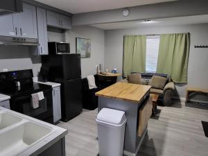 a kitchen and living room with a table and a couch at Grove Street Couplet #2 in Baker City