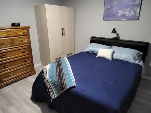 a bedroom with a large bed and a dresser at Grove Street Couplet #2 in Baker City