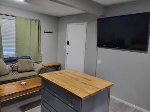 a living room with a large flat screen tv on the wall at Grove Street Couplet #2 in Baker City