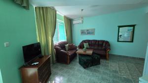 a living room with a couch and a tv at Villa Nora in Albena