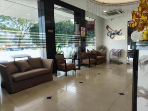 a lobby with couches and chairs in a store at Country Hotel in Klang
