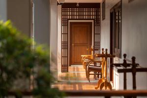 a table and chairs in front of a door at Rimping Village in Chiang Mai +136 photos