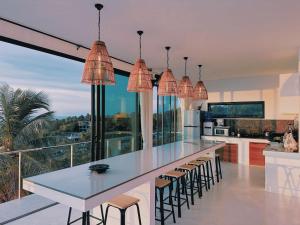 a kitchen with a large island with chairs and a counter at Villa Valentin in Salad Beach