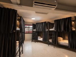 a room with a bunch of bunk beds at TUKTUK Home in Samphanthawong