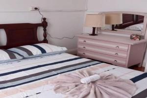 a bedroom with a bed with a dresser and a mirror at The Ashford Hotel and Restaurent in Ashford