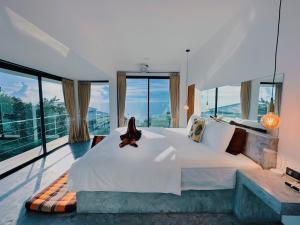 a bedroom with a large bed and large windows at Villa Valentin in Salad Beach +36 photos