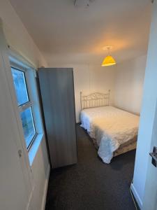 a small bedroom with a bed and a window at Kinsale town centre 3 in Kinsale
