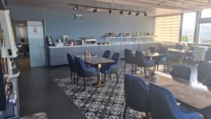 a restaurant with tables and chairs and a counter at Hotel Selenay in Istanbul