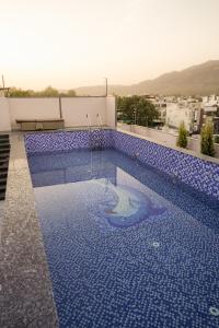 a swimming pool on the roof of a building at Hotel Chhaya in Rishīkesh