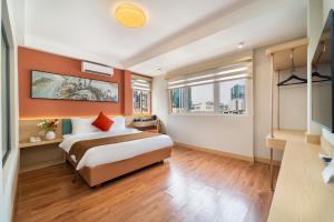 a hotel room with a bed and a window at Vibe Hotel Managed By Nicecy in Ho Chi Minh City