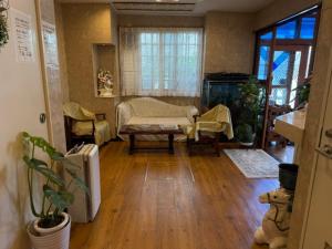 a living room with a couch and a table at ビジネスイン拝島 in Akishima