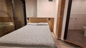 a bedroom with a bed and a shower in a bathroom at Lucas House in Bibbona