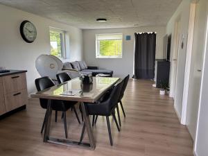 a dining room and living room with a table and chairs at New apartment, only 4 km from the highway in Horsens +14 photos