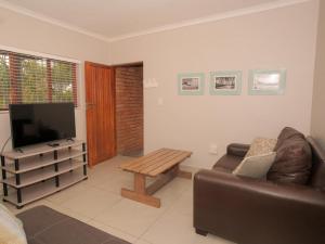 a living room with a couch and a coffee table at Uitspan No 5 in St Lucia
